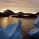 Icebergs floating as the sun rises near Kulusuk, Greenland.